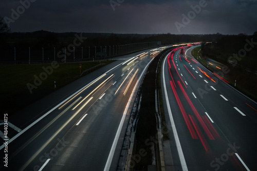 Lights of driving cars on a highway at night in Germany  long exposure with motion blur  copy space
