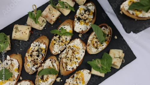 small canapes and French bread sandwiches on a tray. snacks on the table, catering concept. 