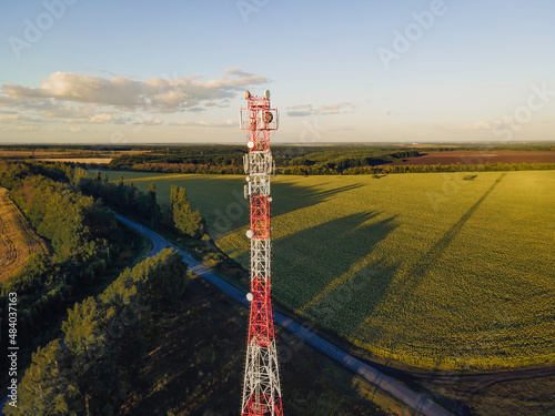 Cell site of telephone tower with 5G base station transceiver. Aerial view of telecommunication antenna mast