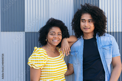 Ethnic man with overjoyed girlfriend on street