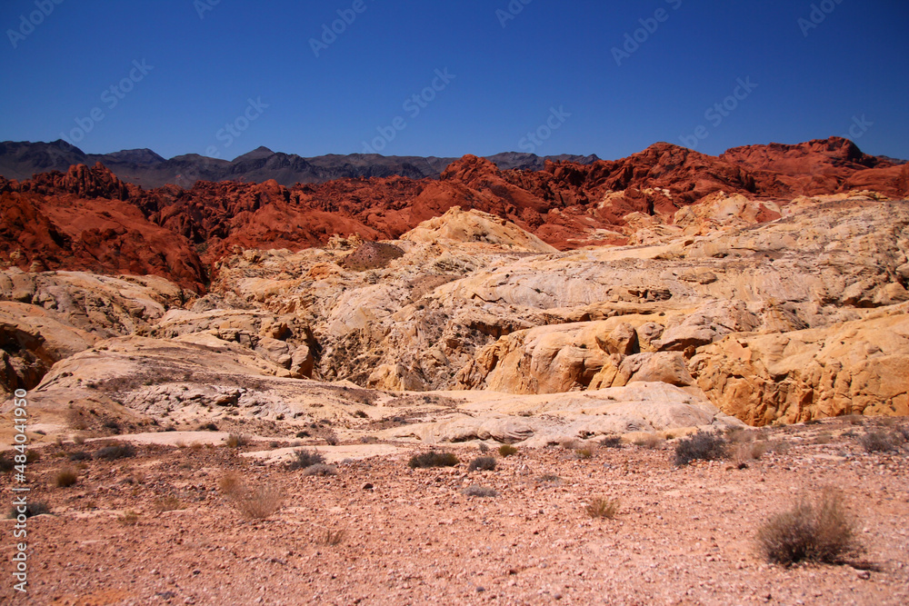 The arid desert, the pink rocks, the red boulders and the brown mountains The arid desert, the pink rocks, the red boulders and the brown mountains