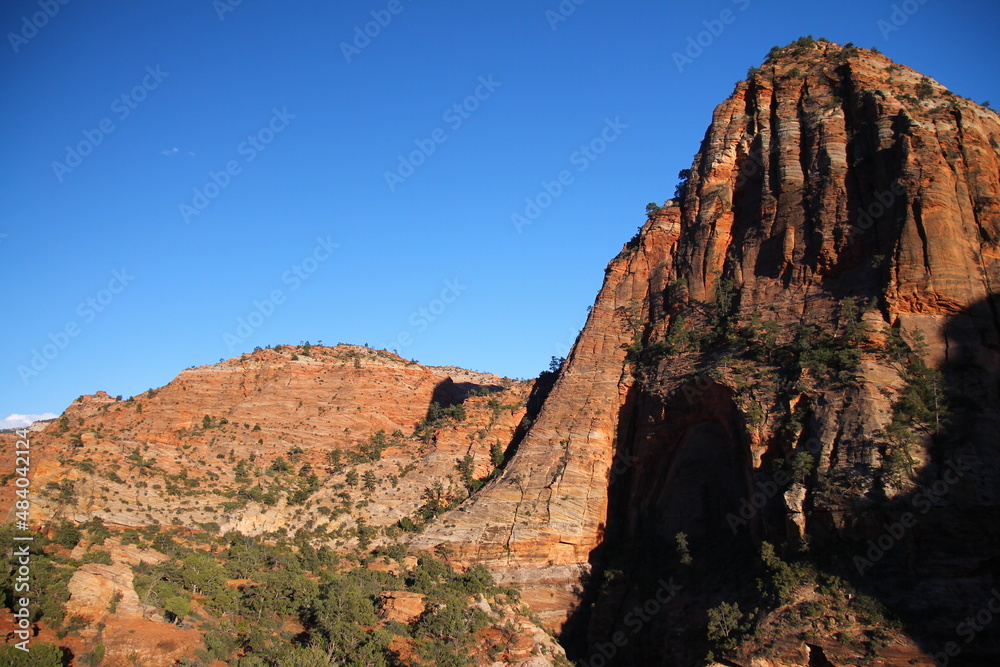 The vertical slope from a peak in Zion National Park during sunset