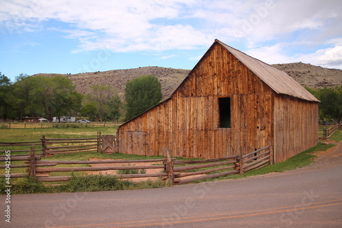 The traditional Gifford Homestead wooden house with the red gravel road