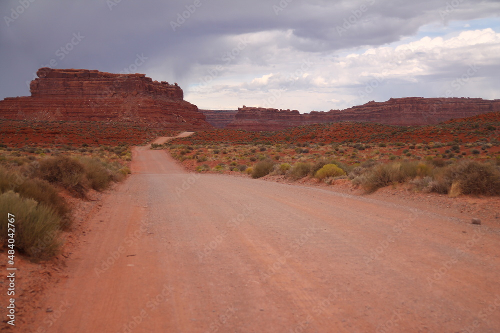 The long gravel road in the red rocks of the Valley of the Gods