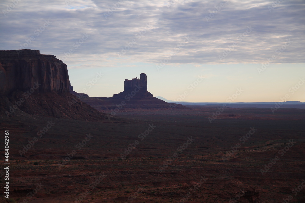 The dark colors of the Monument Valley during a sunset of a rainy day
