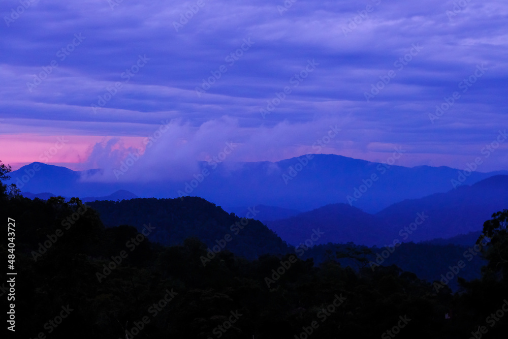 Background image of silhouette mountain range during dusk in Fraser Hill, Pahang, Malaysia.