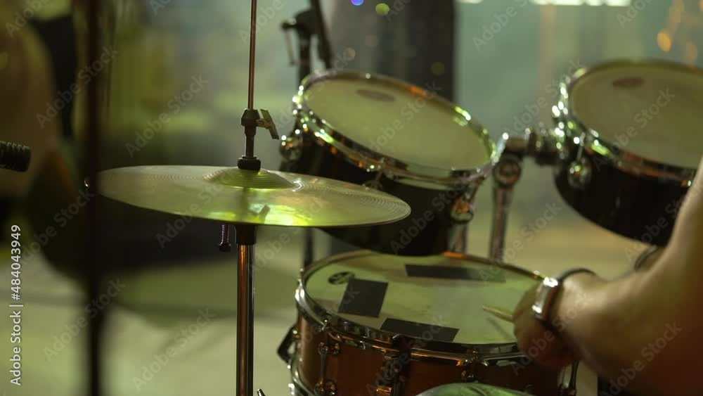 Drummer musician playing drums at concert. Percussion musical instruments on stage. Man with drumsticks, rhythm and beat. Music band, stage light. Drummer musician playing drums at concert. Percussion musical instruments on stage. Man with drumsticks, rhythm and beat. Music band, stage light.
