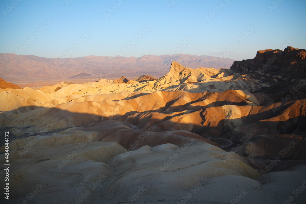 The sun of the morning highlights the dunes and colors of Zabriskie Point in the Death Valley desert