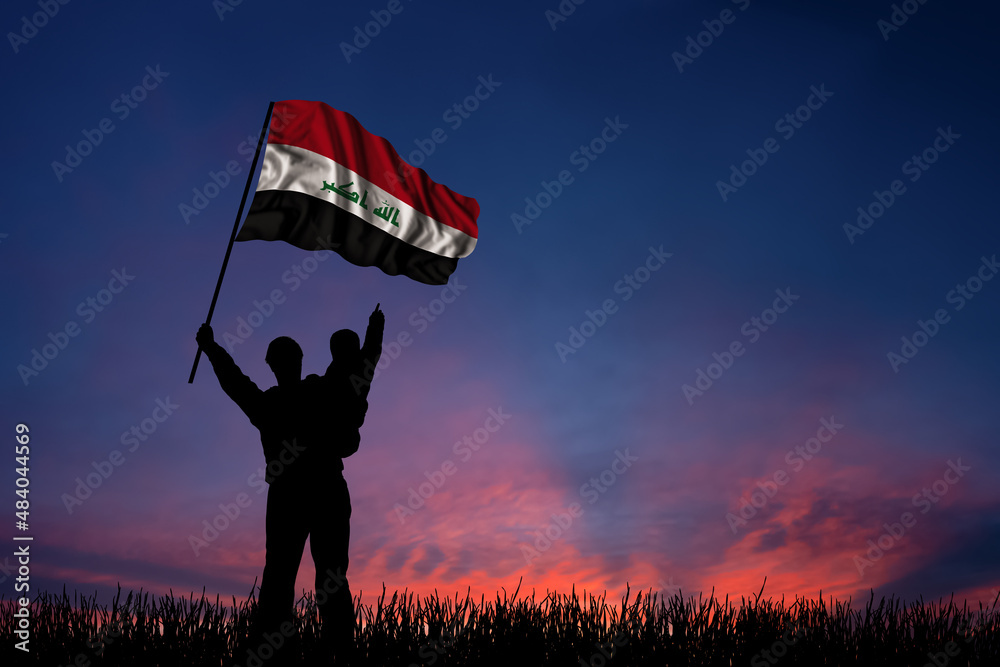 Father and son hold the flag of Iraq