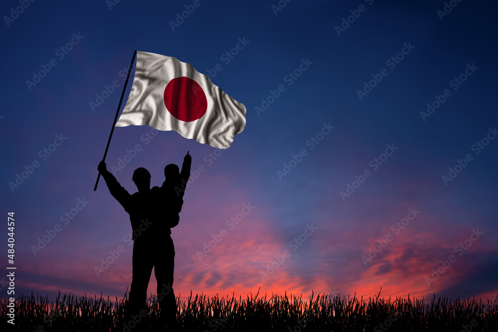 Father and son hold the flag of Japan