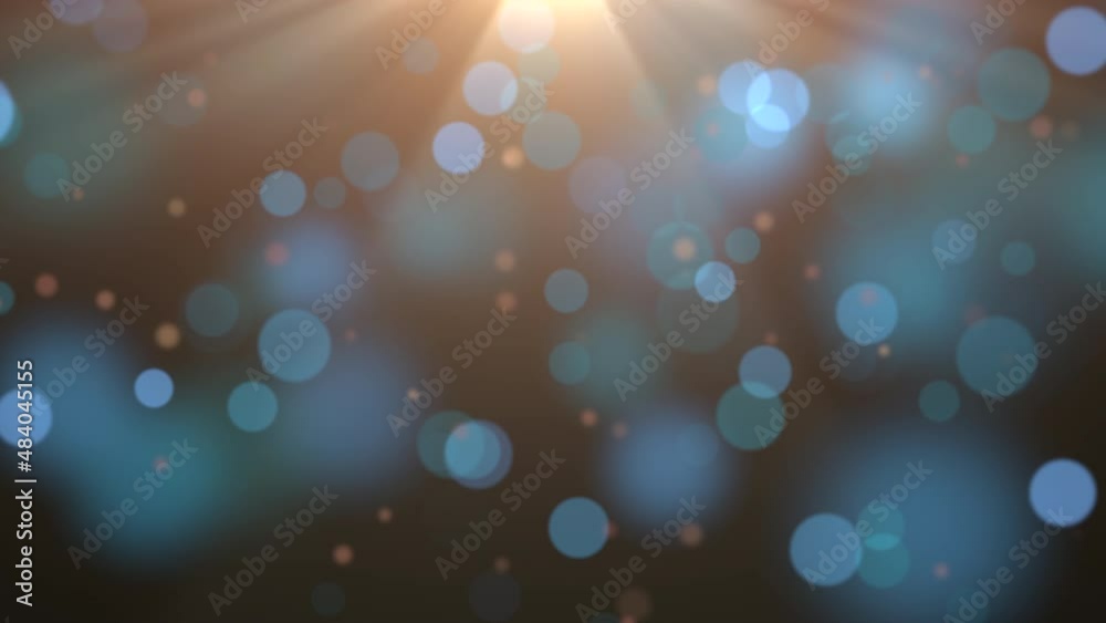 Big blue round bokeh with gold rays on dark background, abstract cinematic and holiday style