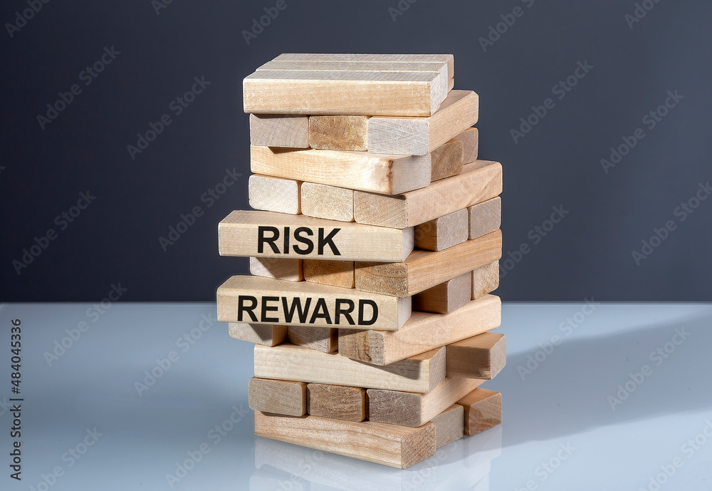 The text on the wooden blocks RISK REWARDD The text on the wooden blocks RISK REWARDD