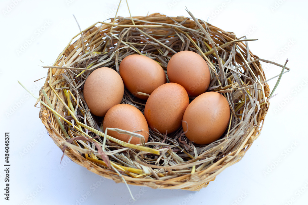 Fresh organic eggs in a straw nest Fresh organic eggs in a straw nest