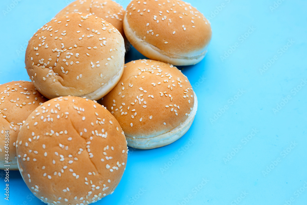 Hamburger buns with sesame on blue background.