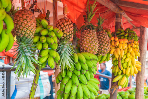 Bananas and pineapples hang under the roof of street shop in Zanzibar, Tanzania.
