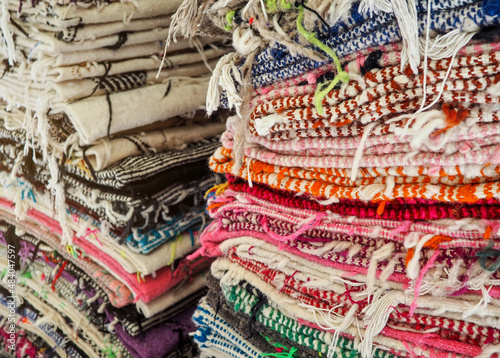 Colourful textile rugs or blankets displayed on street market in Marrakesh  Morocco - closeup detail
