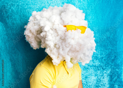 Young careless man with huge cloud of cotton on head photo