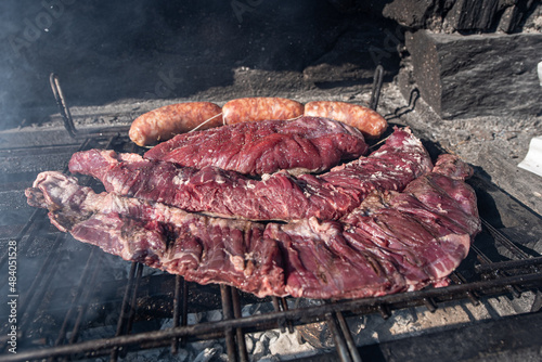 Typical Uruguayan and Argentine Asado Cooked on fire. Entrana and Vacio meat cuts. Accompanied with Chorizo.
 photo
