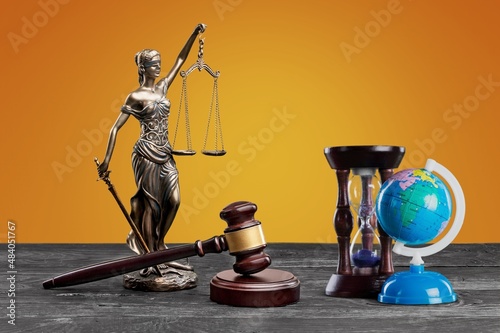 Wooden gavel hammer and globe against background