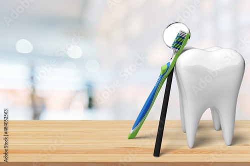 on the table a beautiful white tooth with dentist's dental instruments. © BillionPhotos.com