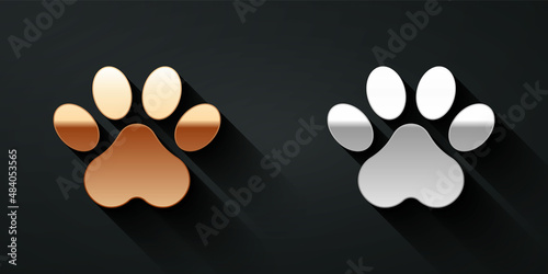 Gold and silver Paw print icon isolated on black background. Dog or cat paw print. Animal track. Long shadow style. Vector