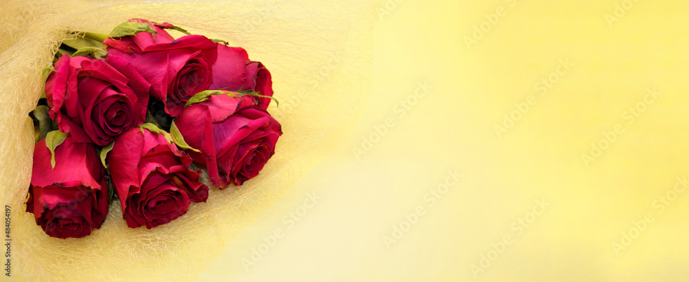 Bouquet of red roses lies on a yellow background Bouquet of red roses lies on a yellow background