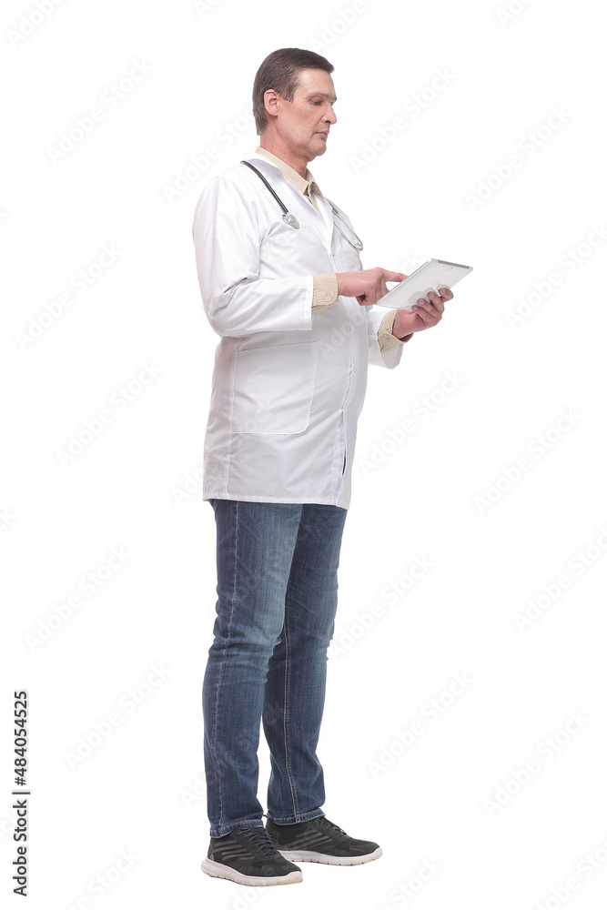 Side view of confident doctor wearing uniform and glasses using digital tablet Side view of confident doctor wearing uniform and glasses using digital tablet