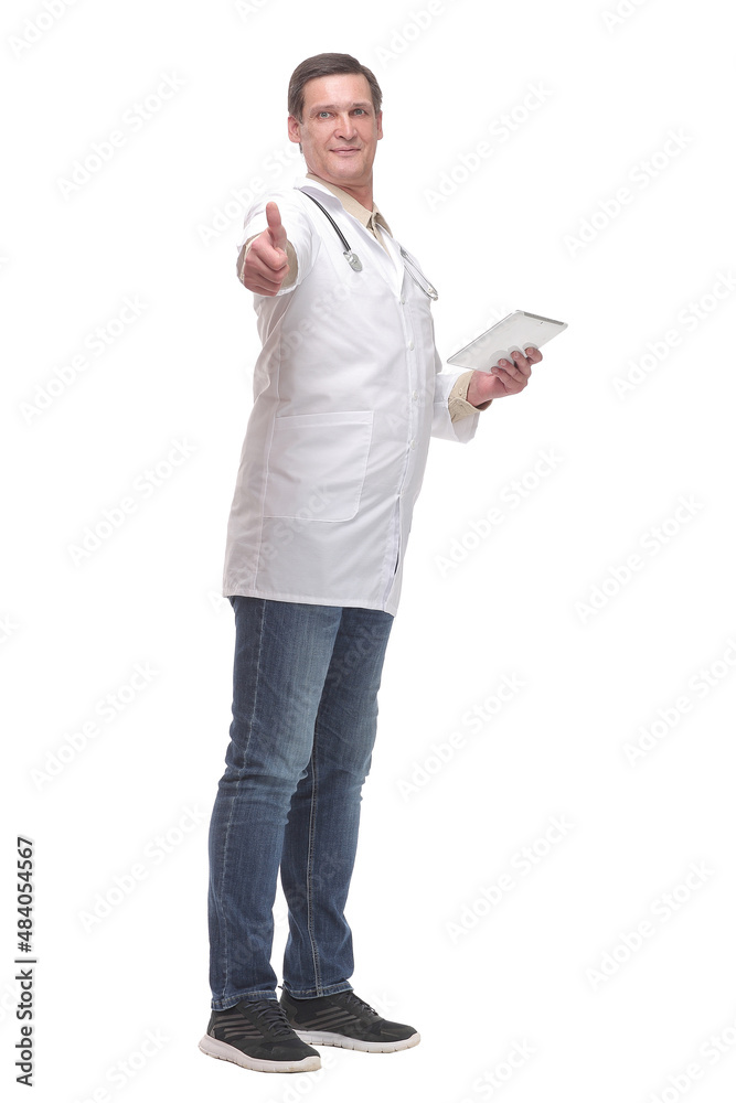 Side view of confident doctor wearing uniform and glasses using digital tablet Side view of confident doctor wearing uniform and glasses using digital tablet