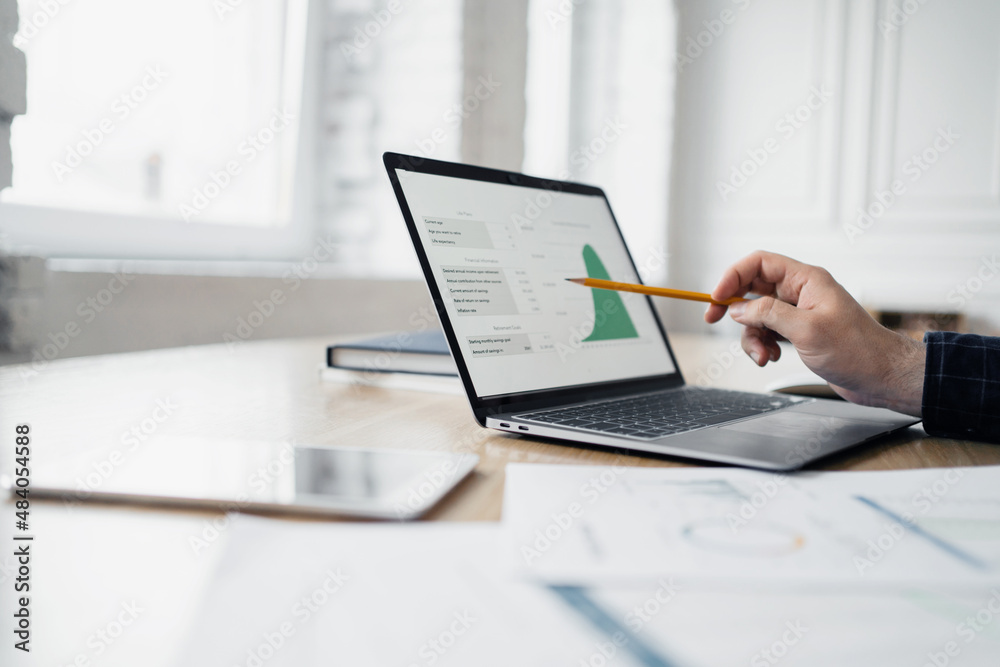 Uses laptop and fountain pen, businessman report in company office, Uses laptop and fountain pen, businessman report in company office,