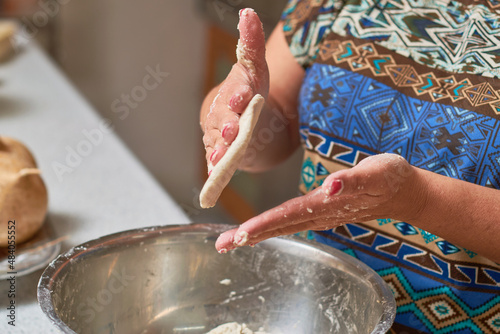 Mexican woman prepares corn tortillas or sopes with her hands. photo