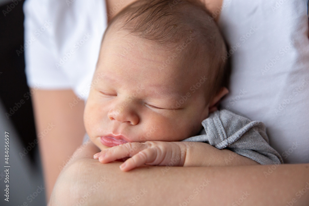 Portrait of a sleeping baby in his mother's arms Portrait of a sleeping baby in his mother's arms