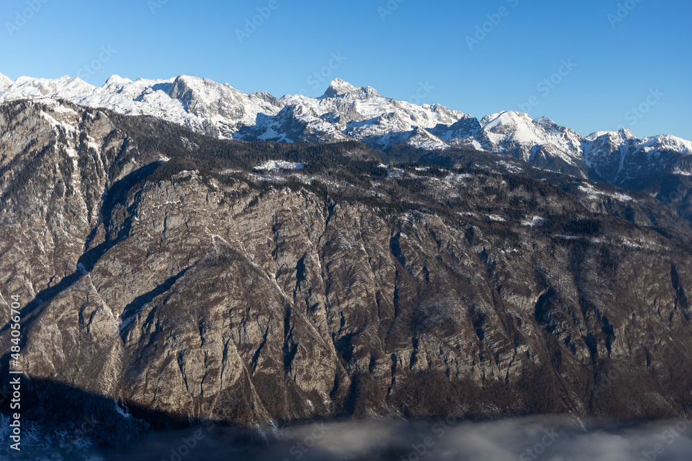 mountain peaks covered with snow over grey rocks