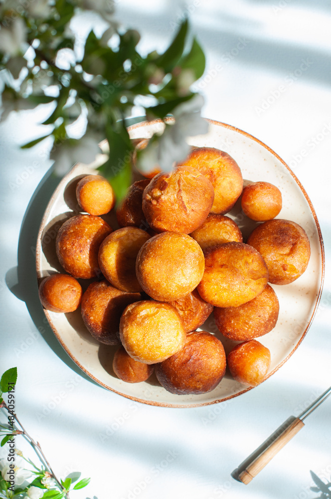 Fried doughnuts on a plate. Top view. Fried doughnuts on a plate. Top view.