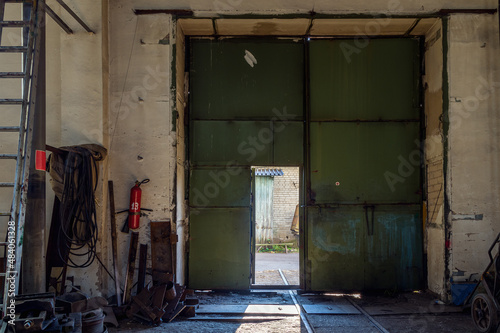 open iron door inside the warehouse © Sergey