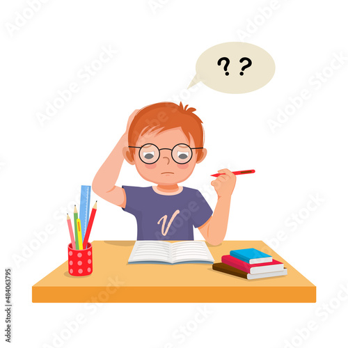 little boy scratching head, confused and having problems when doing his difficult math homework at the desk