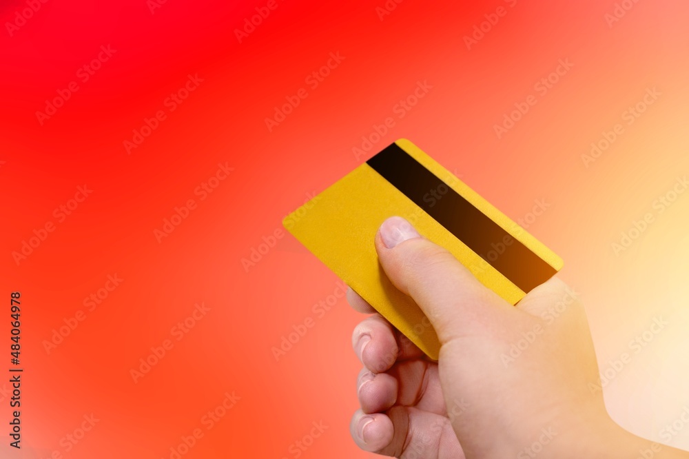 Young female hand and template Bank credit card with online service on background Young female hand and template Bank credit card with online service on background