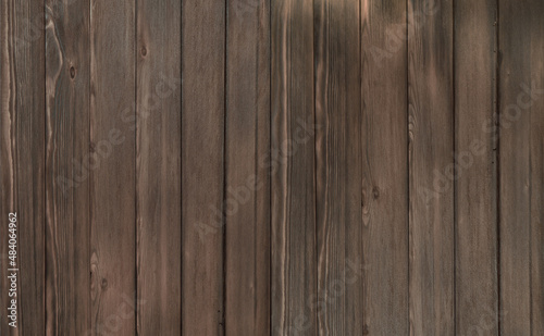wood texture background coming from natural tree. The wooden Brown panel has a beautiful dark pattern