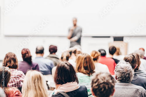 Man giving presentation in lecture hall at university.