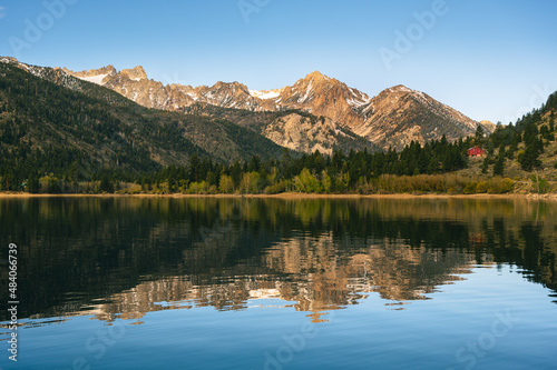 Yosemite mountains reflect on the surface of nearby lake.