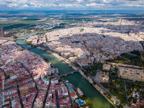 Majestic panorama of Spanish city of Seville on both sides of Guadalquivir river on spring day