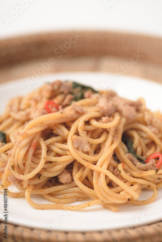 Spicy stir fried Spaghetti with chicken and basil leaf