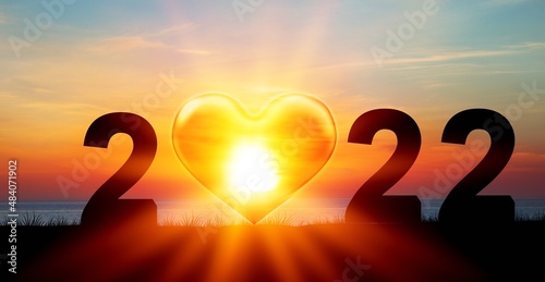 Concept of new year 2022. Silhouette of sun against blue sky background.