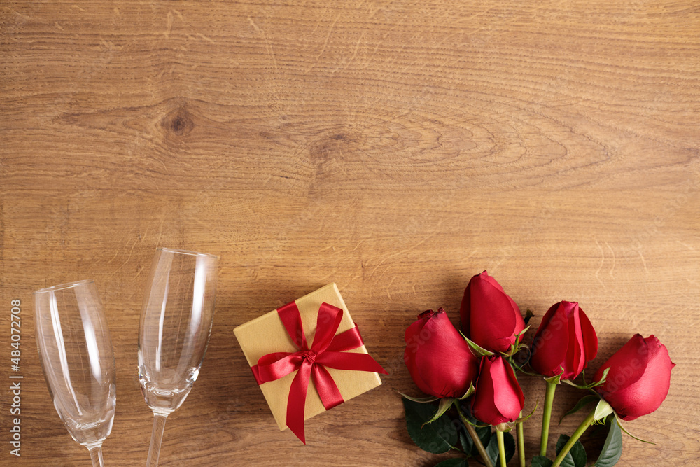 red rose flowers and gift box on wooden background red rose flowers and gift box on wooden background