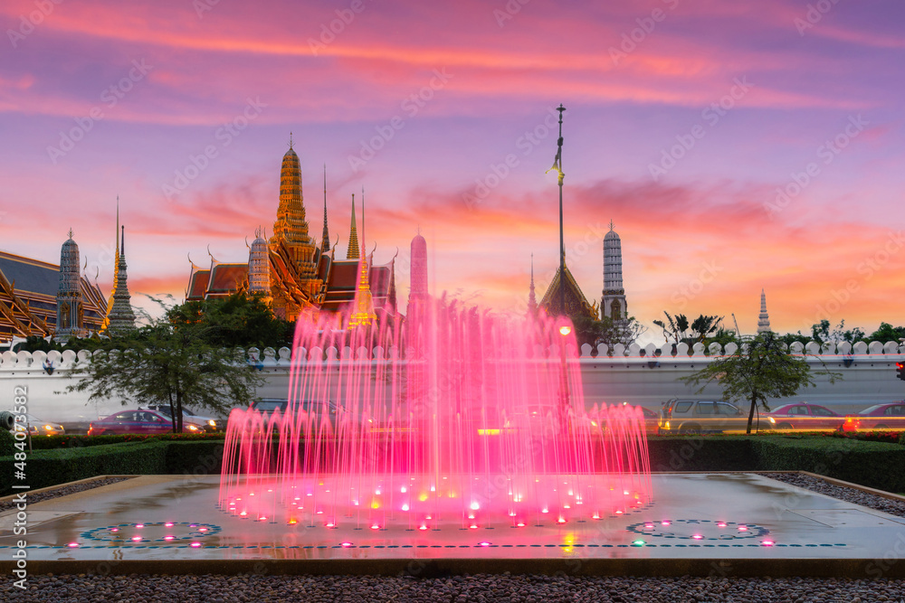 Bangkok, Thailand, fountain show with Wat Phra Kaew temple in the background and a beautiful sunset sky background.