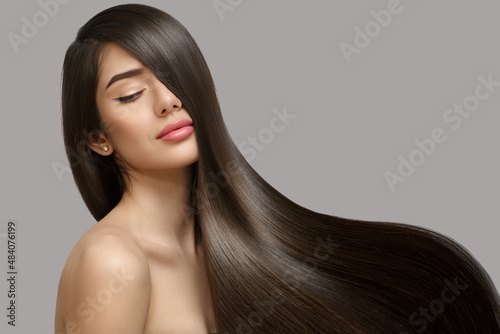 Valokuvatapetti Fashion woman with straight long shiny hair. Beauty and hair care