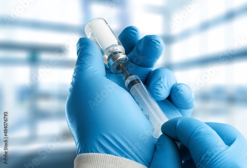 Injectable vaccine for the vaccination program of coronavirus Omicron. Doctor holds the syringe
