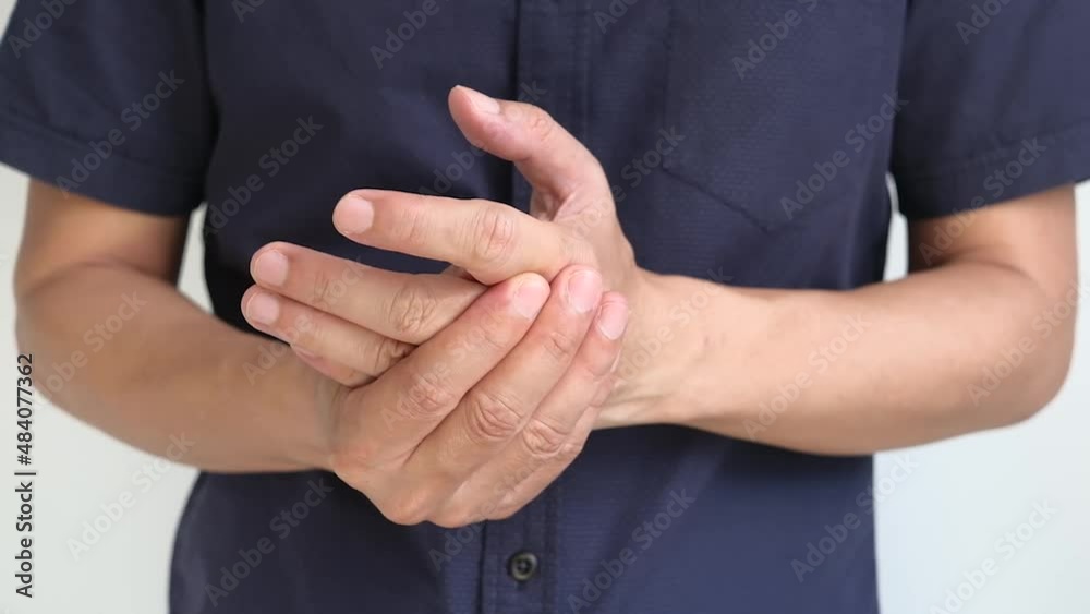 man touching wrist and thumb He squeezed his thumb and wrist. He had a