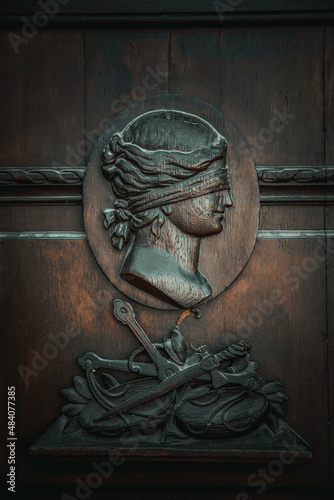 bas-relief of Themis on the wooden door of the court