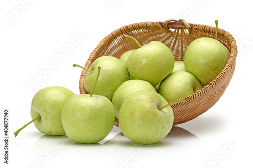 basket with green apples on white.