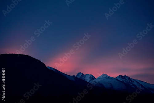 Sunrise colors the morning sky over Alaska s Chugach Range. 